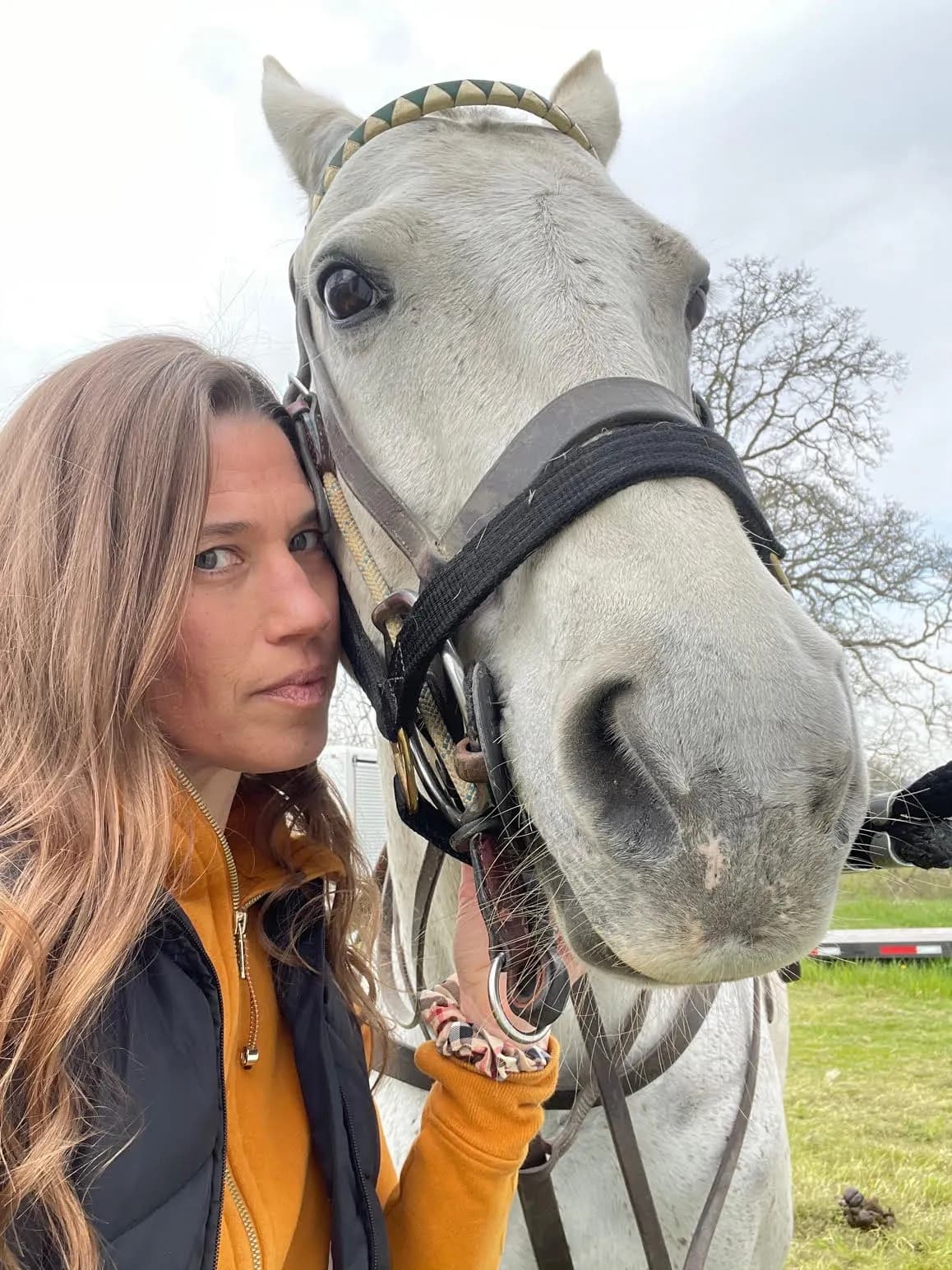Robin Johnson sharing a quiet moment with a horse by the fence